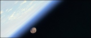 A shuttle astronaut’s view of Earth with the Moon in the distance. (NASA)